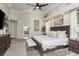Spacious main bedroom with a tray ceiling, king bed, ceiling fan and neutral-toned decor at 10342 Altrara Way, Trinity, FL 34655