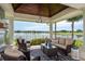 Covered patio with comfortable seating and stunning lake and golf course views at 10342 Altrara Way, Trinity, FL 34655