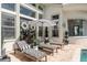 A relaxing patio with lounge chairs, striped umbrella, and view of the waterway at 10342 Altrara Way, Trinity, FL 34655