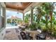 Tranquil patio area overlooking a pool, spa, and lush tropical landscaping in the backyard at 10342 Altrara Way, Trinity, FL 34655