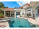 Expansive backyard pool and spa with covered patio and lounge area at 10342 Altrara Way, Trinity, FL 34655