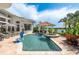 Gorgeous backyard pool and spa area with outdoor kitchen and lake view at 10342 Altrara Way, Trinity, FL 34655