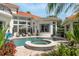 Stunning pool and spa area with lush landscaping, perfect for outdoor entertaining at 10342 Altrara Way, Trinity, FL 34655