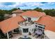 Lovely terracotta roof home boasts a spacious balcony, outdoor seating, private pool, and lush landscaping at 10342 Altrara Way, Trinity, FL 34655