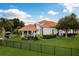 A beautiful home with a terracotta roof, pristine landscaping, putting green and an inviting outdoor living area at 10342 Altrara Way, Trinity, FL 34655