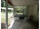 View from porch showcasing lush greenery, seating, and yard at 1042 Howell Ave, Brooksville, FL 34601
