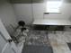 Basement featuring concrete floors, a table, and two chairs near a small window at 1042 Howell Ave, Brooksville, FL 34601