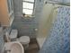 Bright bathroom with tiled walls, vanity, toilet, and shower at 1042 Howell Ave, Brooksville, FL 34601