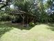 Car port with vehicle, lawn mower, and storage at 1042 Howell Ave, Brooksville, FL 34601