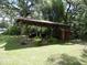 A spacious carport protects vehicles from the elements with additional storage to the side at 1042 Howell Ave, Brooksville, FL 34601