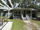 Charming house with a pergola, welcoming porch, and well-manicured lawn at 1042 Howell Ave, Brooksville, FL 34601