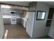 Updated kitchen with gray cabinets, white appliances, and a modern backsplash at 1042 Howell Ave, Brooksville, FL 34601