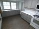 Bright kitchen featuring gray cabinets, white countertops, and modern appliances at 1042 Howell Ave, Brooksville, FL 34601