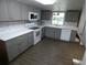 Well-lit kitchen showcasing gray cabinets, white countertops, and stainless steel appliances at 1042 Howell Ave, Brooksville, FL 34601