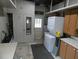 Functional laundry area with washer, dryer, storage cabinets, and access to the backyard at 1042 Howell Ave, Brooksville, FL 34601