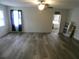 Bright and airy living room with updated flooring, ceiling fan, and lots of natural light at 1042 Howell Ave, Brooksville, FL 34601