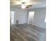 Spacious living room with neutral walls, wood-look floors, and ample natural light at 1042 Howell Ave, Brooksville, FL 34601