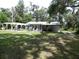 Expansive backyard features a covered patio and pergola, perfect for outdoor entertaining at 1042 Howell Ave, Brooksville, FL 34601