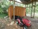 Lawn tractor parked near a storage shed at 1042 Howell Ave, Brooksville, FL 34601