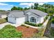 A beautiful aerial view of a well-manicured home with lush landscaping and a charming facade at 10935 New Brighton Ct, New Port Richey, FL 34654