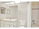 Clean, well-lit bathroom featuring a vanity with sink, toilet, and shower with curtain at 10935 New Brighton Ct, New Port Richey, FL 34654