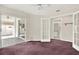 Neutral bedroom showcasing a sliding glass door to the outdoor space and an attached bathroom at 10935 New Brighton Ct, New Port Richey, FL 34654