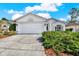 Charming single-story home featuring a well-maintained lawn and a two-car garage at 10935 New Brighton Ct, New Port Richey, FL 34654