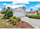 Charming single-Gathering home with an attached two-car garage, driveway, and appealing curb appeal, with mulch and greenery at 10935 New Brighton Ct, New Port Richey, FL 34654