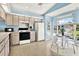 Cozy eat-in kitchen with white appliances and an oversized window with charming breakfast nook at 10935 New Brighton Ct, New Port Richey, FL 34654