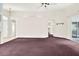 Open living room boasts a ceiling fan and neutral paint, offering a bright and airy atmosphere at 10935 New Brighton Ct, New Port Richey, FL 34654