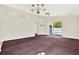 Open living room features a ceiling fan and sliding glass doors to let in natural light at 10935 New Brighton Ct, New Port Richey, FL 34654
