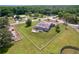 Aerial view showcasing property with fenced backyard, a screened in pool and mature shade trees at 10941 Hilltop Dr, New Port Richey, FL 34654