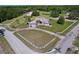 Aerial view of lovely home featuring a three-car garage, circular driveway, fenced yard and mature trees at 10941 Hilltop Dr, New Port Richey, FL 34654
