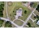 Stunning aerial view of estate home showcasing screened pool, circular driveway and horse training ring at 10941 Hilltop Dr, New Port Richey, FL 34654