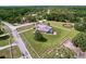 Aerial view of gorgeous home on acreage featuring a horse training ring and a screened in pool at 10941 Hilltop Dr, New Port Richey, FL 34654