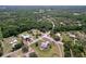 Expansive aerial view of a countryside home with a screened pool and surrounded by lush trees and greenery at 10941 Hilltop Dr, New Port Richey, FL 34654