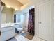Bright bathroom features a shower-tub combo, white tiled floors, and a toilet at 10941 Hilltop Dr, New Port Richey, FL 34654