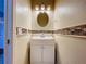 Bathroom featuring modern vanity, decorative mirror and accent tile at 10941 Hilltop Dr, New Port Richey, FL 34654