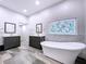 A spacious bathroom featuring a soaking tub, double sinks, decorative stained glass at 10941 Hilltop Dr, New Port Richey, FL 34654