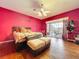 Bedroom with a ceiling fan, hardwood floors, and access to the pool area at 10941 Hilltop Dr, New Port Richey, FL 34654