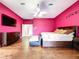 This primary bedroom features a ceiling fan, hardwood floors, and a wide dresser at 10941 Hilltop Dr, New Port Richey, FL 34654