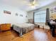 Bedroom with hardwood floors, fan, and neutral-painted walls at 10941 Hilltop Dr, New Port Richey, FL 34654