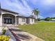 Charming home featuring a well-maintained lawn, landscaping, arched entryway, and brick detailing at 10941 Hilltop Dr, New Port Richey, FL 34654