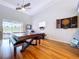 Large game room with hardwood floors, gaming machine and a view to the outside at 10941 Hilltop Dr, New Port Richey, FL 34654