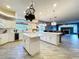 Spacious open-concept kitchen with a central island, granite countertops, stainless steel appliances and wood floors at 10941 Hilltop Dr, New Port Richey, FL 34654