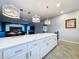 Spacious kitchen island with seating and expansive countertops, seamlessly connecting to the living area at 10941 Hilltop Dr, New Port Richey, FL 34654