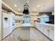 Bright and airy kitchen with an island, modern appliances, pendant lights, and lots of cabinet space at 10941 Hilltop Dr, New Port Richey, FL 34654