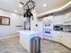 Bright kitchen with island, stainless steel appliances, and white cabinets provides ample counter space at 10941 Hilltop Dr, New Port Richey, FL 34654