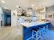 Charming kitchen with seating island, pendant lighting, stainless appliances, and ample counter space at 10941 Hilltop Dr, New Port Richey, FL 34654