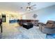 Spacious living room flowing into modern kitchen with large sectional couch and lots of seating at 10941 Hilltop Dr, New Port Richey, FL 34654